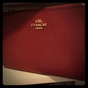 Authentic Coach wristlet with double pockets.